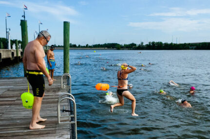 People jump into a swimmable section of the Anacostia River outside of Washington, D.C.