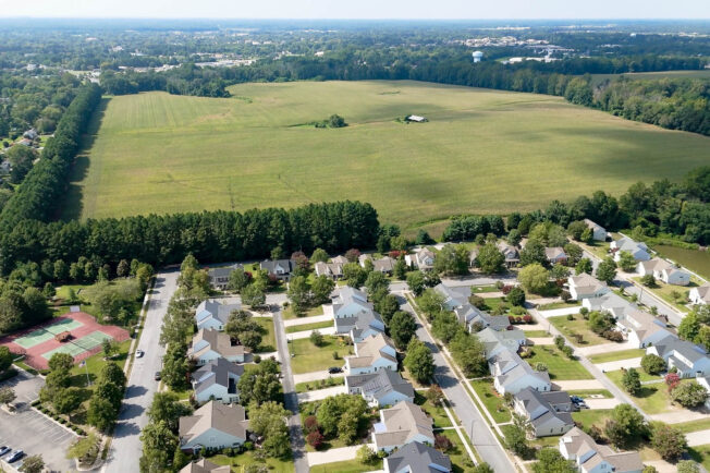 Residential development sprawls next to farmland